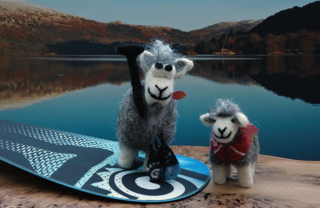 Two paddle boarding Herdies with paddle at Ullswater